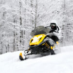 Man on snowmobile in winter mountain