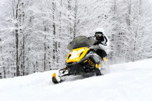 Man on snowmobile in winter mountain