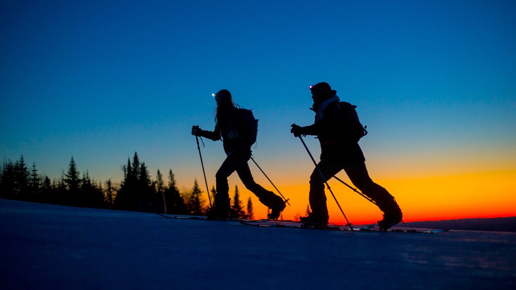Deux skieurs en rando alpine au coucher de soleil